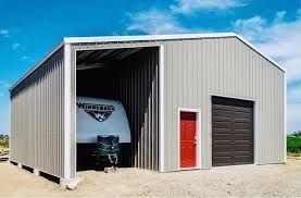 RV Camper parked inside a brown metal storage structure 